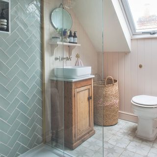 Bathroom with wooden storage cabinet under sink and shower
