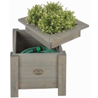 Grey storage unit with lid suitable for plants with a green plant in lid and a hose inside
