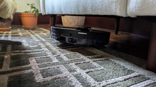 The Shark PowerDetect Robot Vacuum and Mop cleaning under furniture