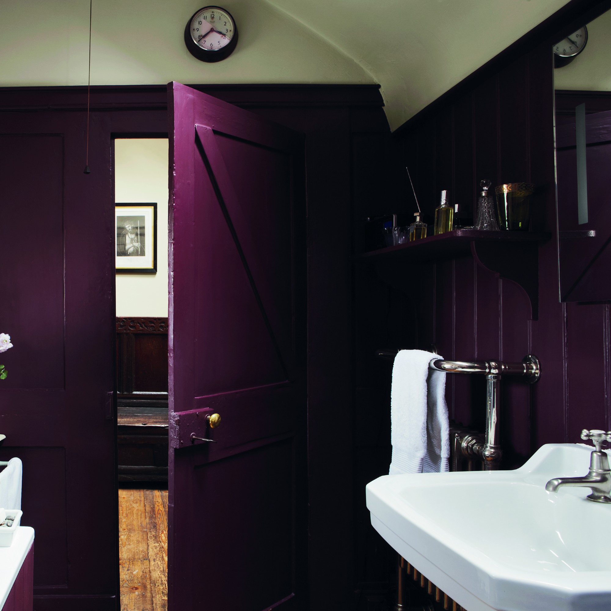 A rusticpanelled bathroom painted in Farrow &amp;amp; Ball Brinjal aubergine shade with a contrasting ceiling