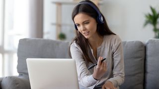 A woman using a laptop to work from home