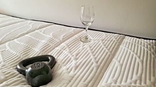 Awara mattress drop test for motion isolation with a 10lb weight and empty wine glass
