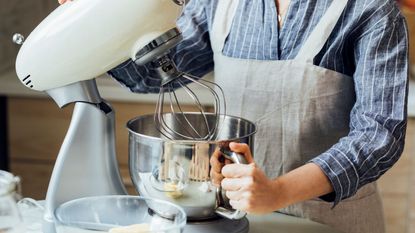 A woman using a stand mixer.