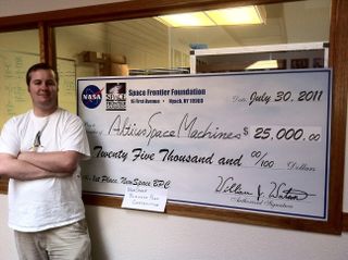 Altius Space Machines won the $25,000 first-place prize at the 2011 Heinlein NewSpace Business Plan Competition. President and CEO Jonathan Goff stands with the prize check.