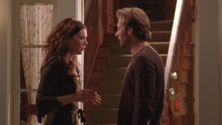 Lauren Graham and Scott Patterson talking in a doorway in Gilmore Girls.