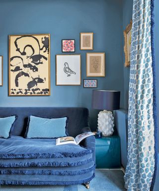 blue living room with art work, white lamp and different fabrics, textures and patterns - Katherine Howard