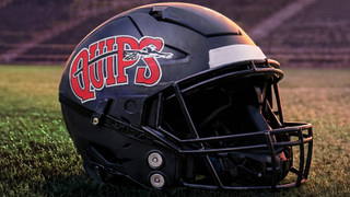 Aliquippa 'Quips' football helmet on grass of football field