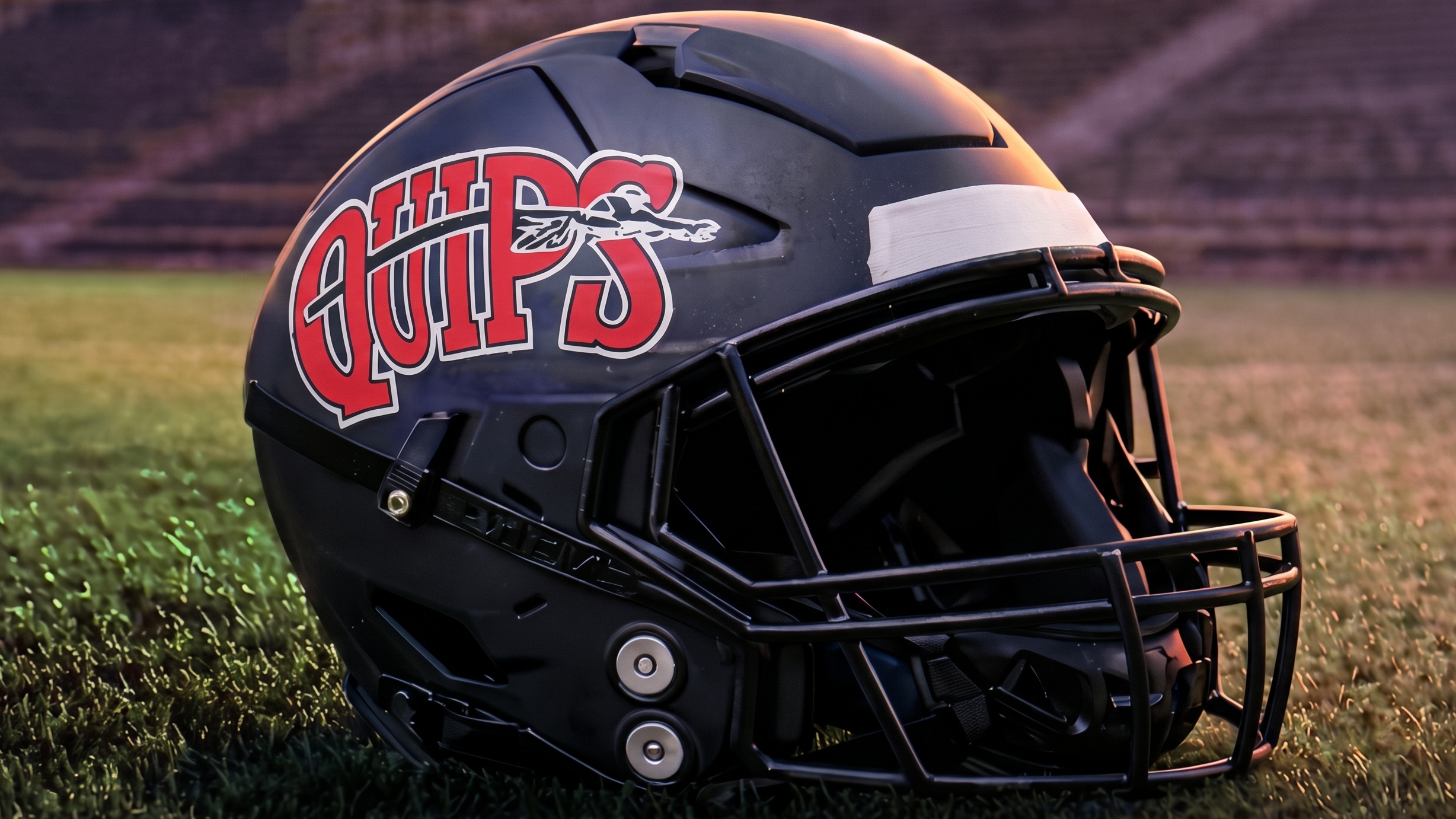 Aliquippa 'Quips' football helmet on grass of football field