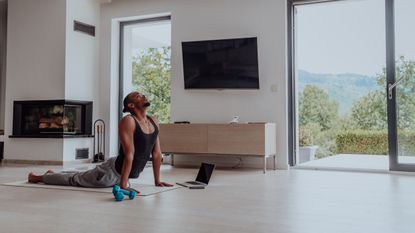 Man practicing yoga at home