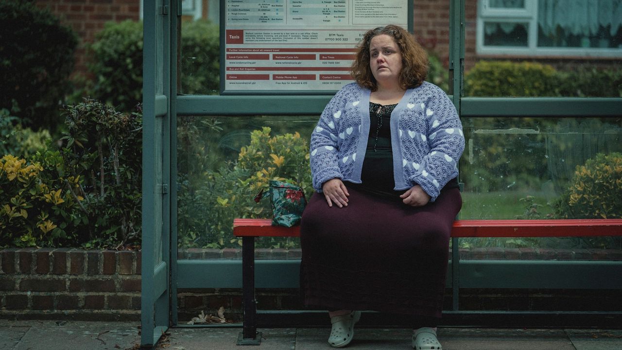 Jessica Gunning as Martha, sitting at a bus stop, in the Netflix series &#039;Baby Reindeer&#039;