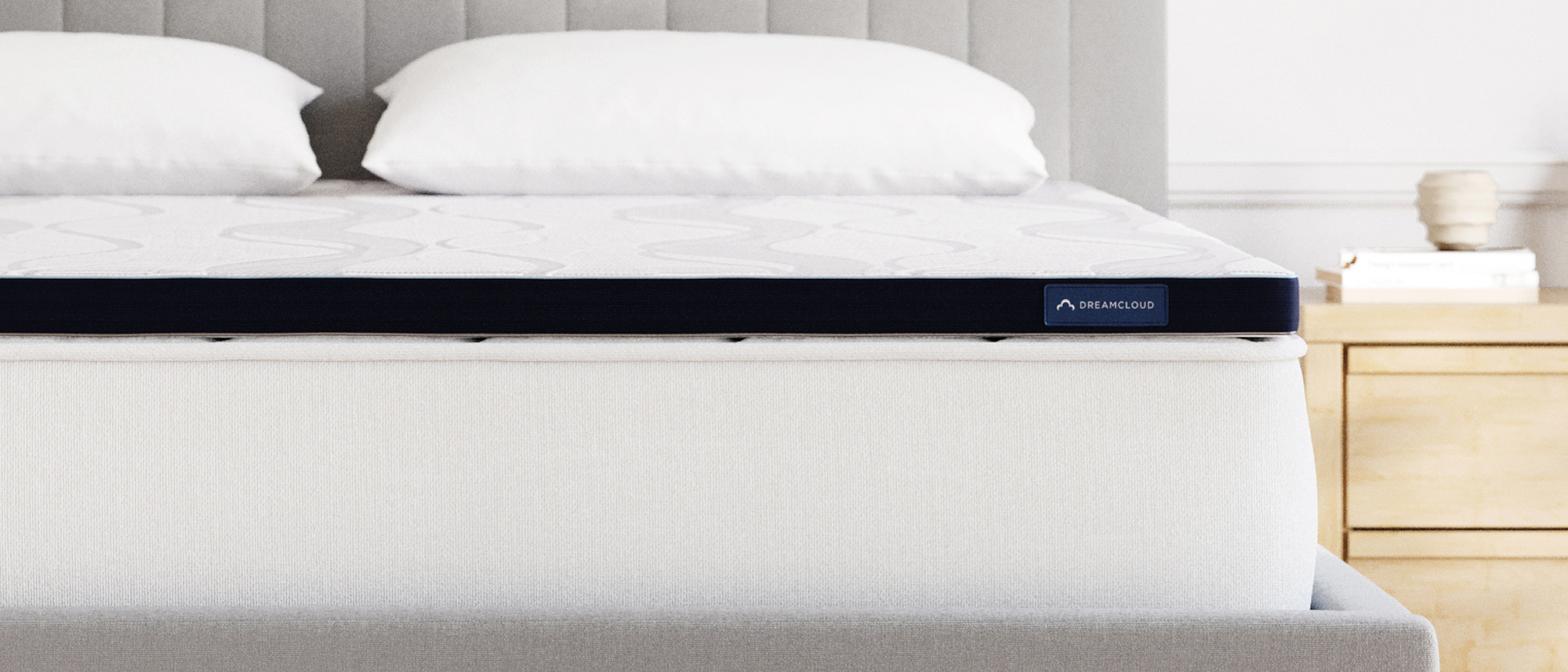 The DreamCloud Softer Mattress Topper on a bed in a bedroom
