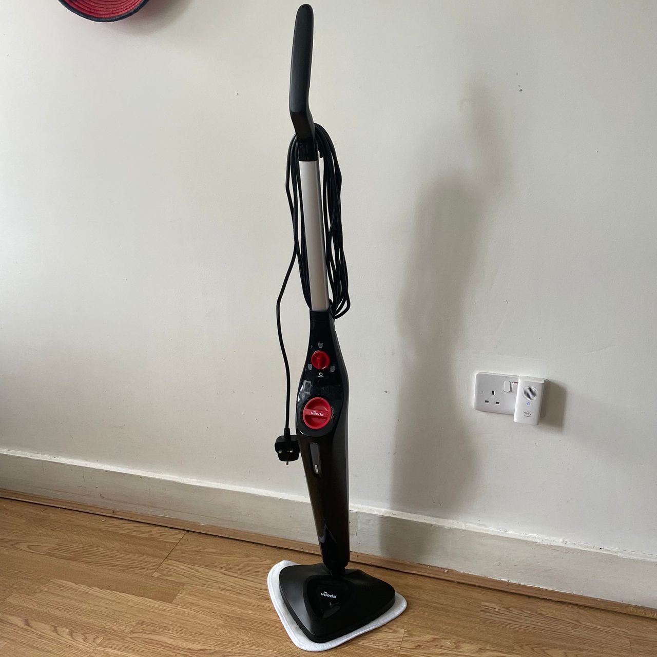 Vileda Steam Mop Plus standing up in front of a white painted wall