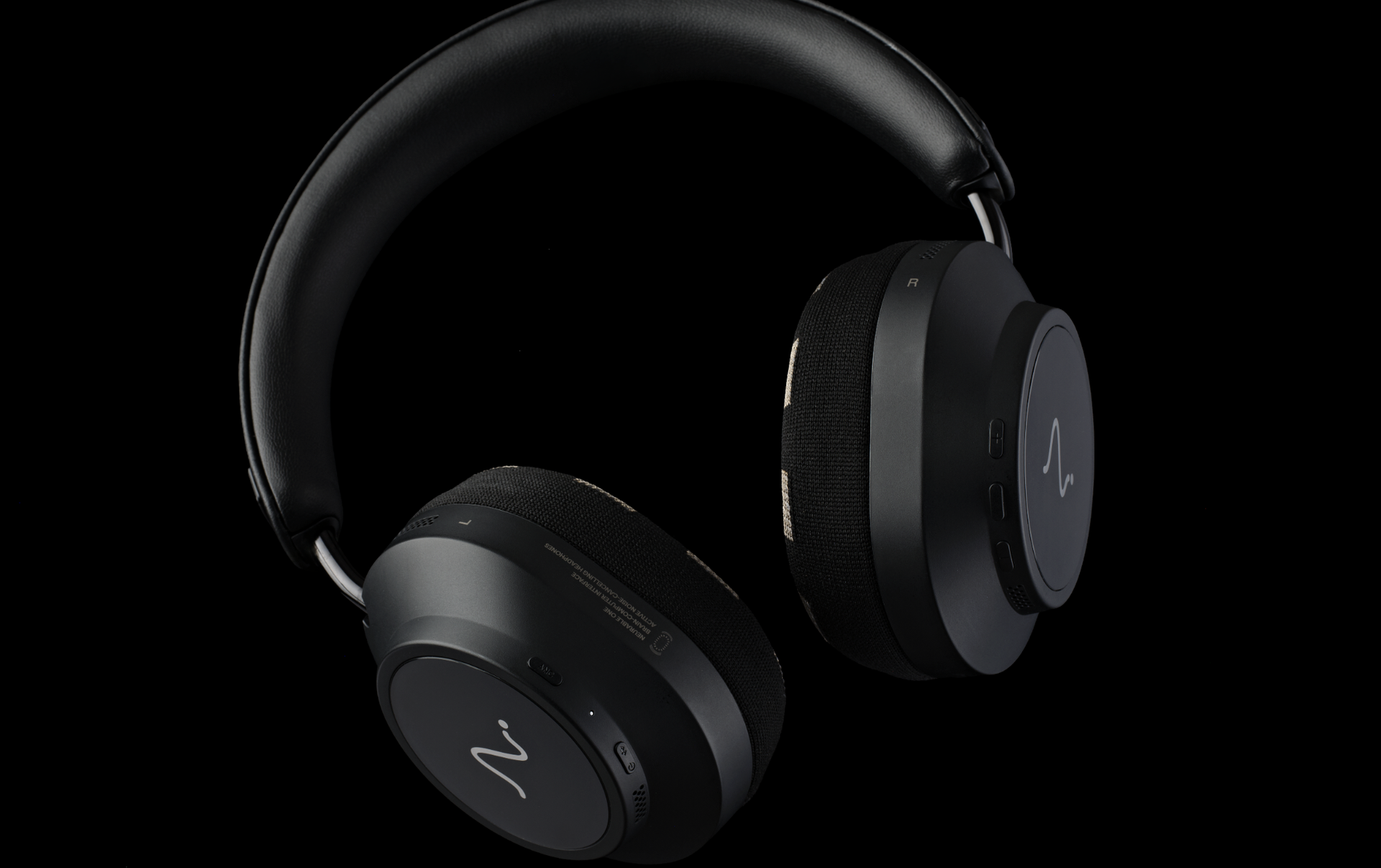 Neurable One headphones on a wooden desk, or on a black background, showing the ear cups