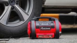 Avid Power Tire Inflator next to car tire
