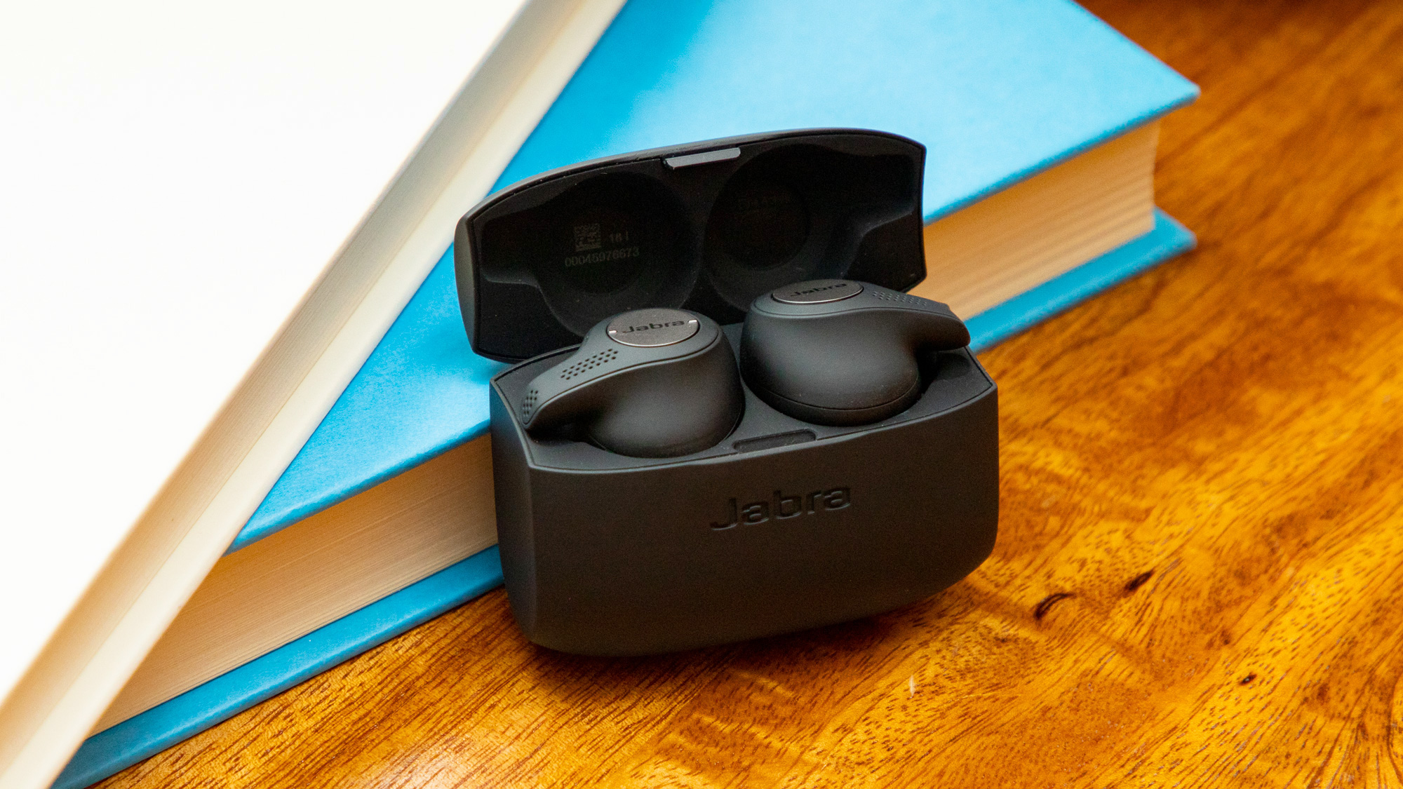 The Jabra Elite Active 65t propped up against a book