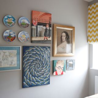 Blue wall with prints and plates hung together