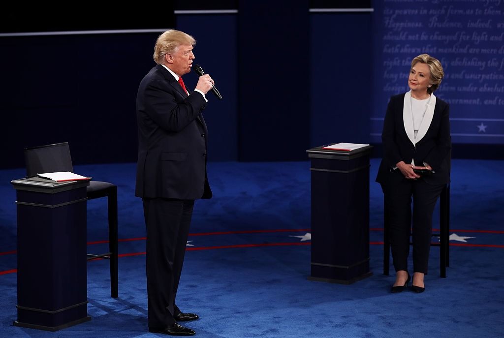 Republican presidential nominee Donald Trump speaks as Democratic presidential nominee Hillary Clinton listens during the town hall-style debate at Washington University om St. Louis, on Oct. 9, 2016.