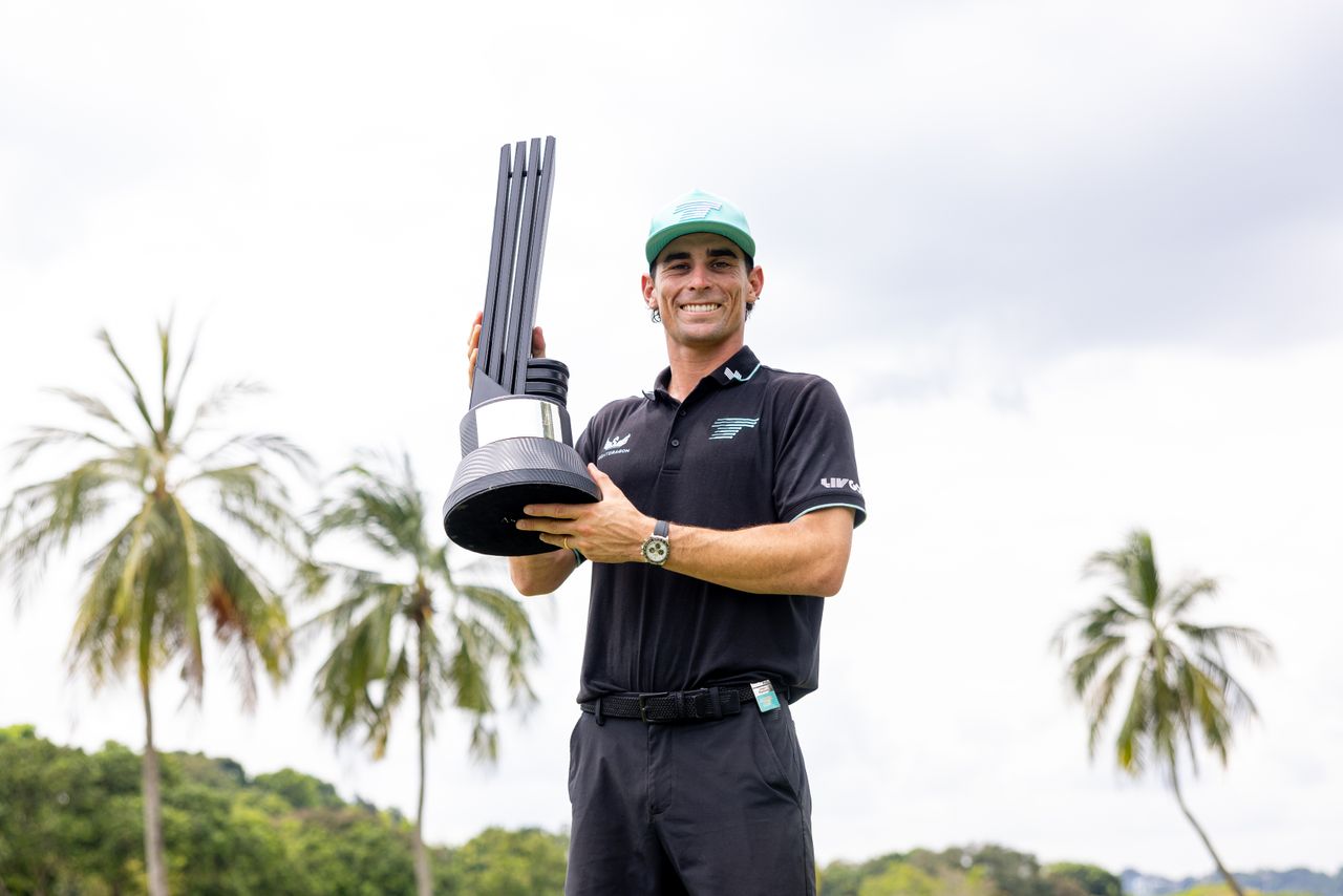 Joaquin Niemann holds a LIV Golf trophy