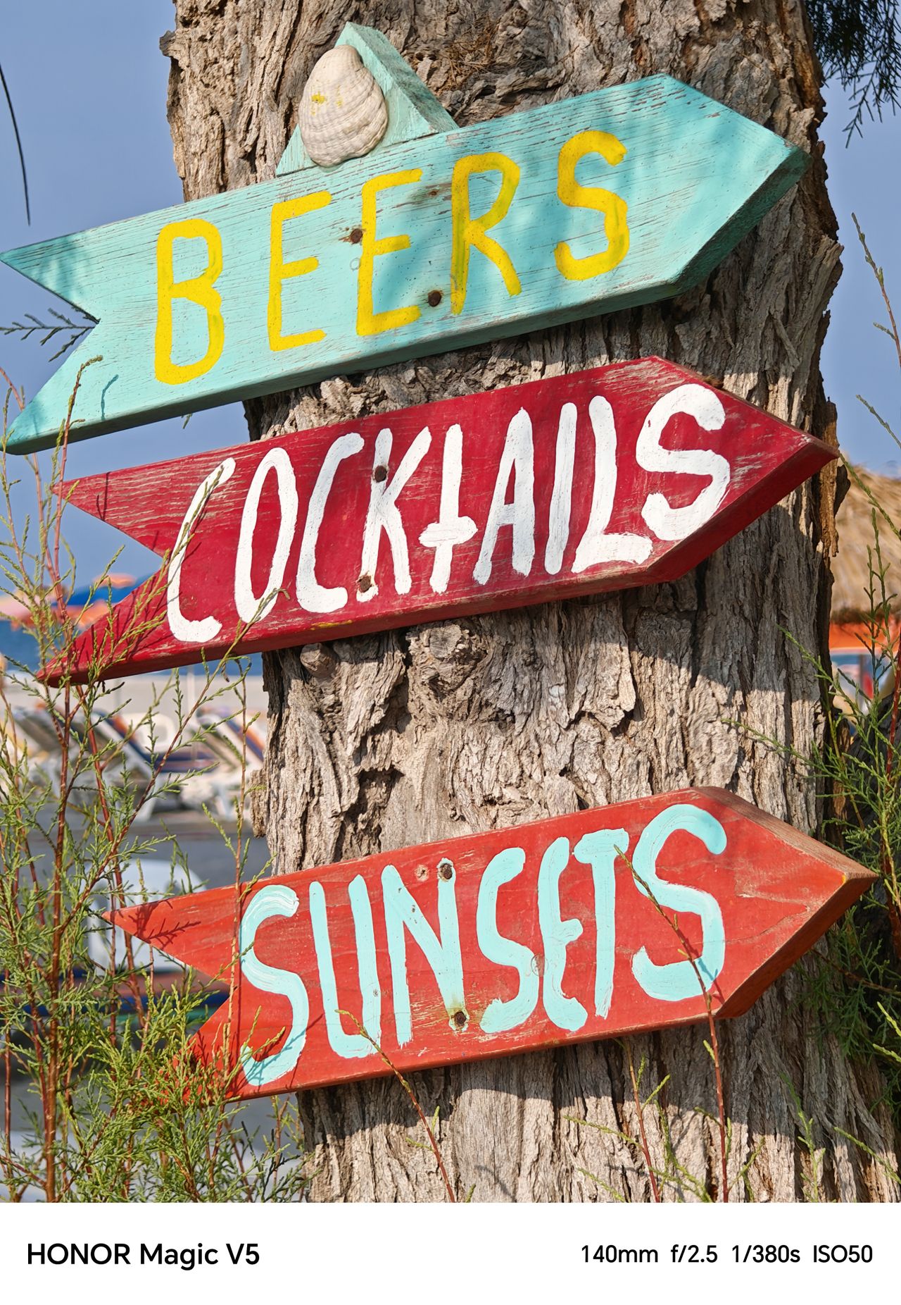 Three arrow signs reading beers, cocktails, sunsets