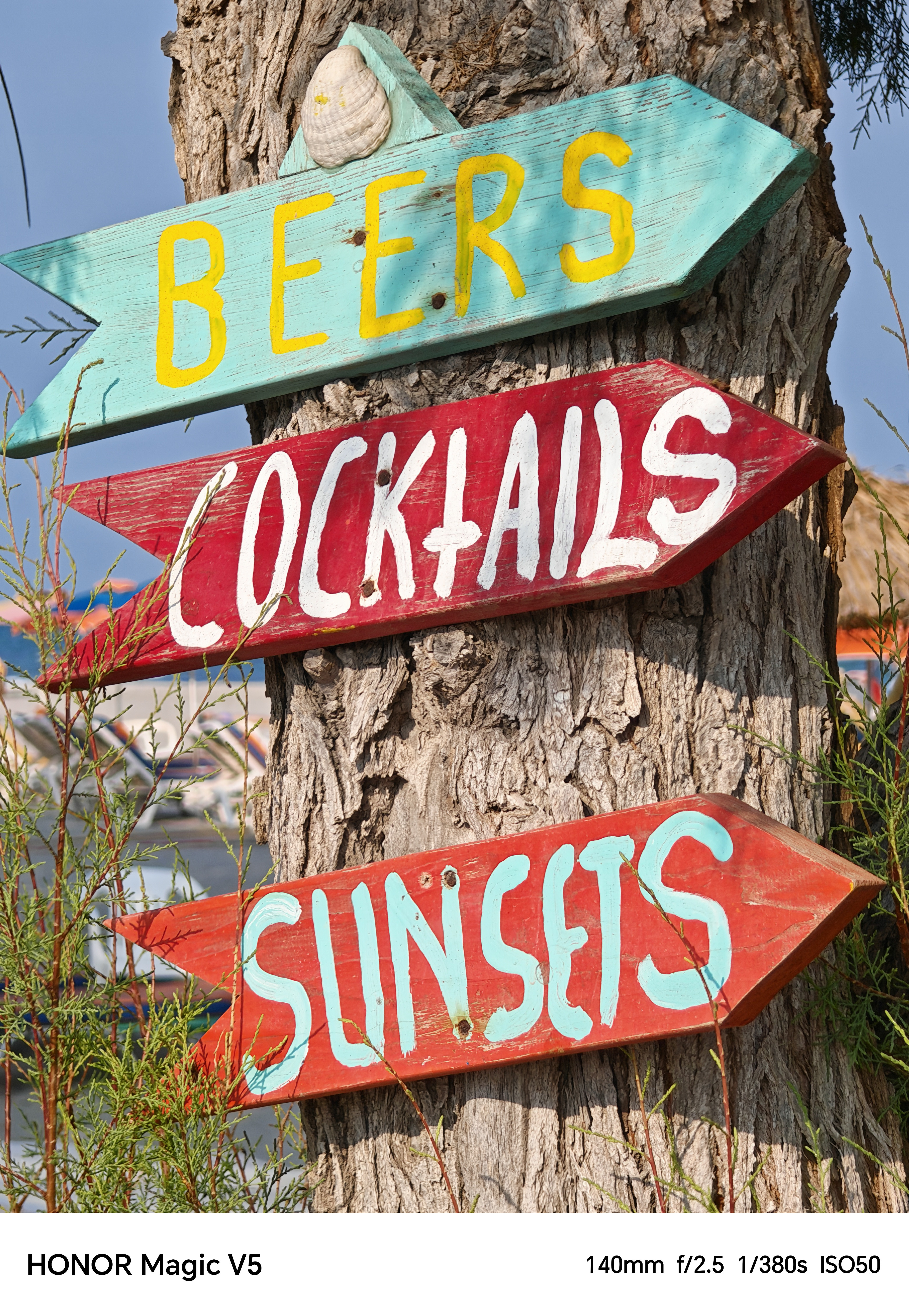 Three arrow signs reading beers, cocktails, sunsets