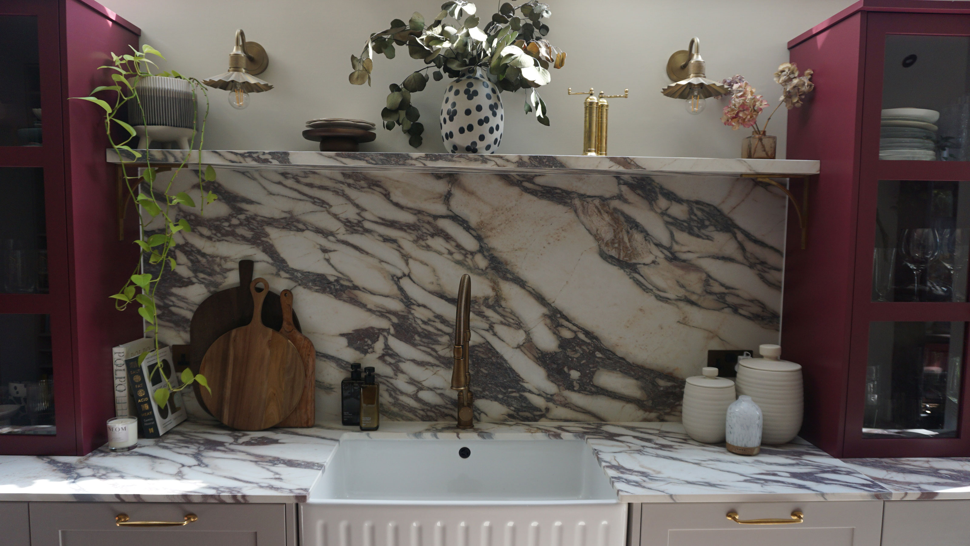Fluted Belfast sink with brass tap on mable worktop and with marble splashback