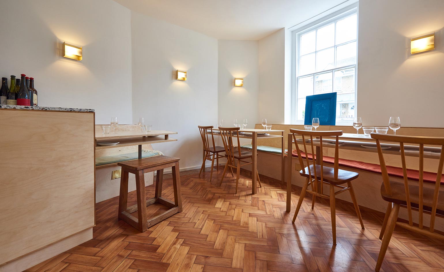 Corner of restaurant with tables & wine counter