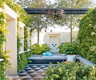 patterned paved courtyard by Kate Gould with living walls