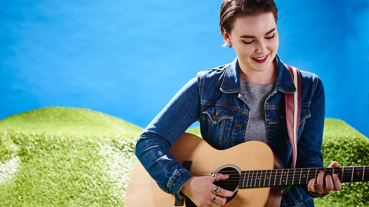 Woman playing acoustic guitar