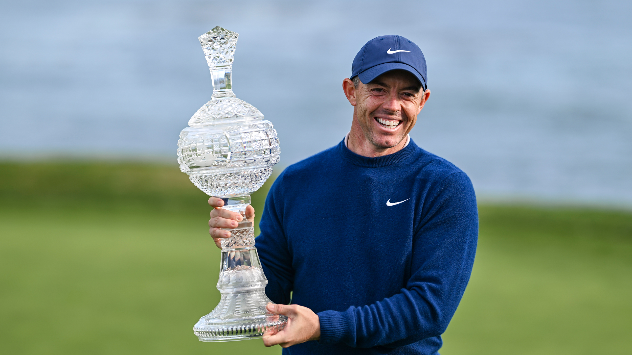 Rory McIlroy posing with the AT&amp;T Pebble Beach Pro-Am trophy following his win in 2025