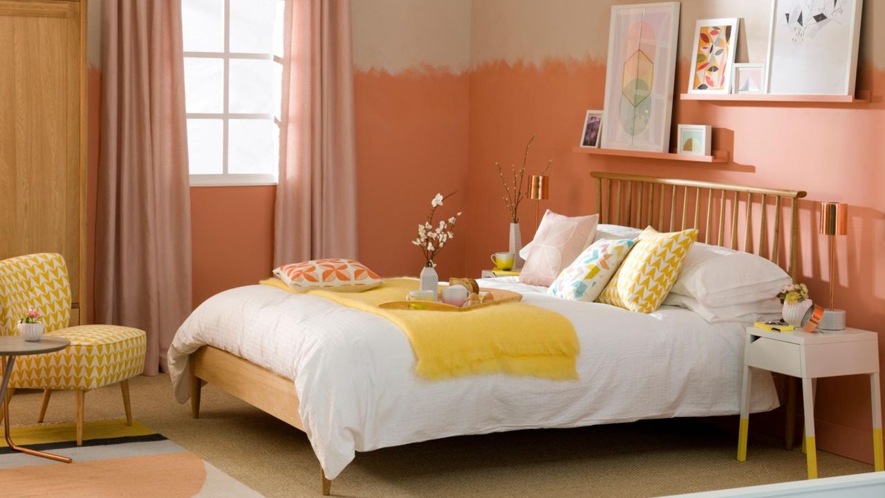 Pale orange bedroom, fitted shelves with framed abstract art, wood double bed position against wall