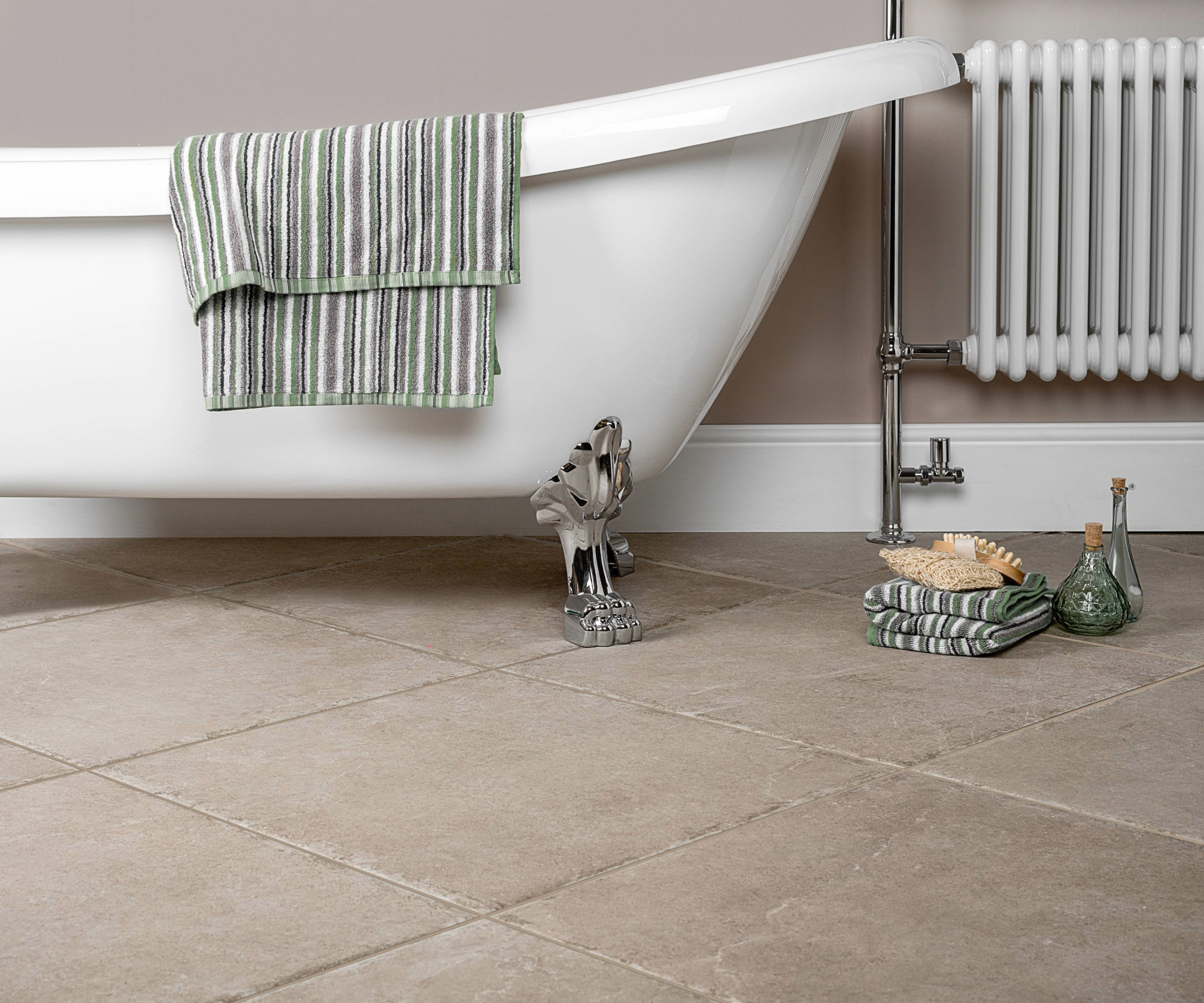 Bathroom with stone tiles and freestanding bath