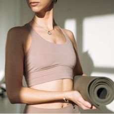 Woman holding a yoga mat