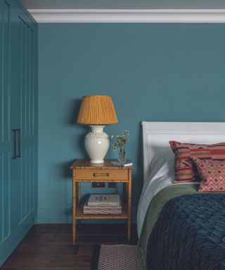 bedroom with bedside table with table lamp and bed