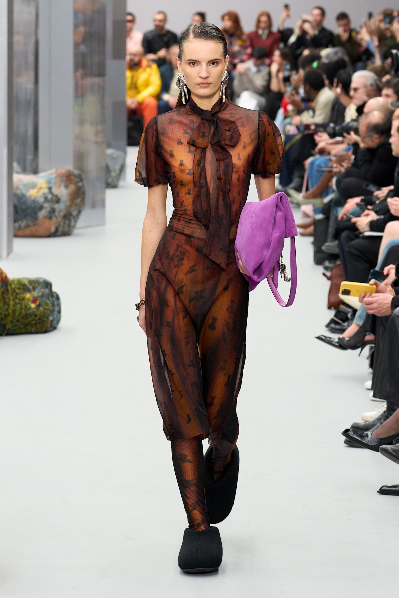 An Acne Studios model wearing pattern tights