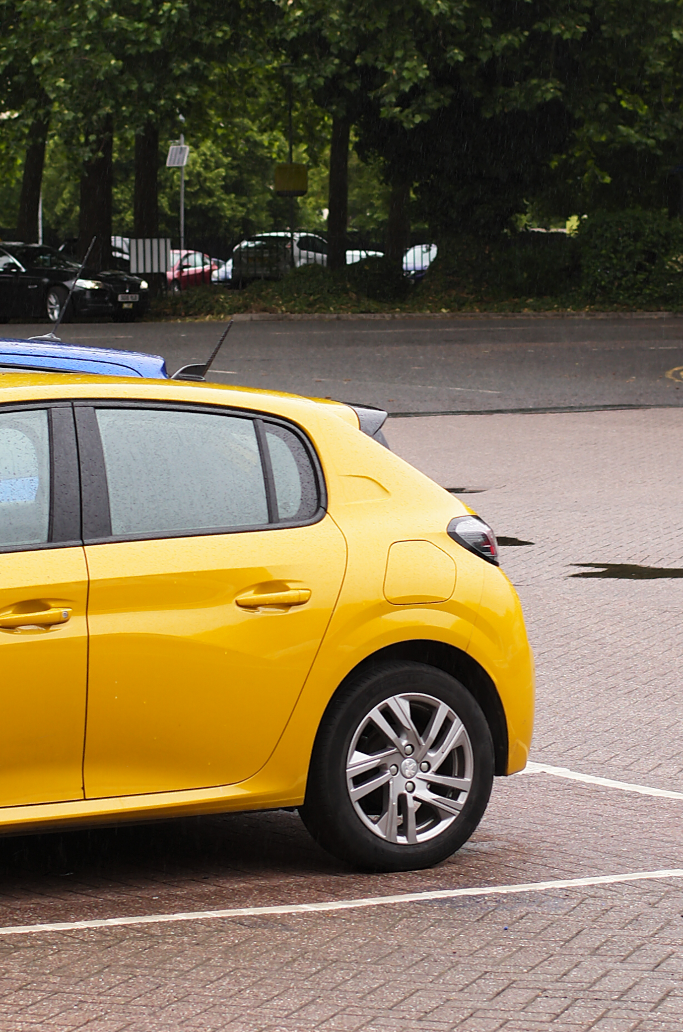 A photo of a yellow car taken on a Leica M11-D rangefinder camera