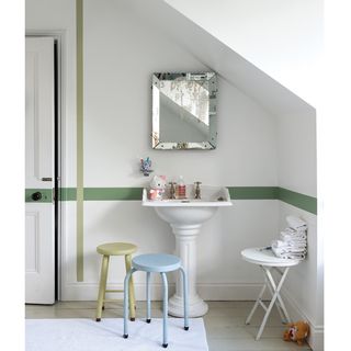 attic room with white walls wash basin and mirror on wall