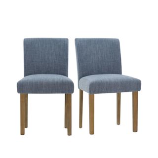 Two denim blue dining chairs with light brown wooden legs