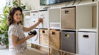 A woman applies labels to her storage boxes