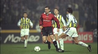 16 Oct 1996: Eric Cantona of Manchester United goes by Ilker of Fenerbahce during the champions League match between Fenerbahce and Manchester United at Fenerbahce Stadium in Turkey. Manchester United went onto win the match by 0-2. Mandatory Credit: Shaun Botterill/Allsport