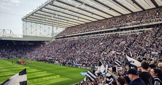 A general view (GV) as Newcastle United fans wave their flags and banners before the Premier League match between Newcastle United and Arsenal FC at St. James Park on May 7, 2023 in Newcastle-upon-Tyne, United Kingdom.