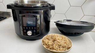 The Instant Pot Pro with the lid removed and a bowl of rice, which has been cooked in the Instant Pot