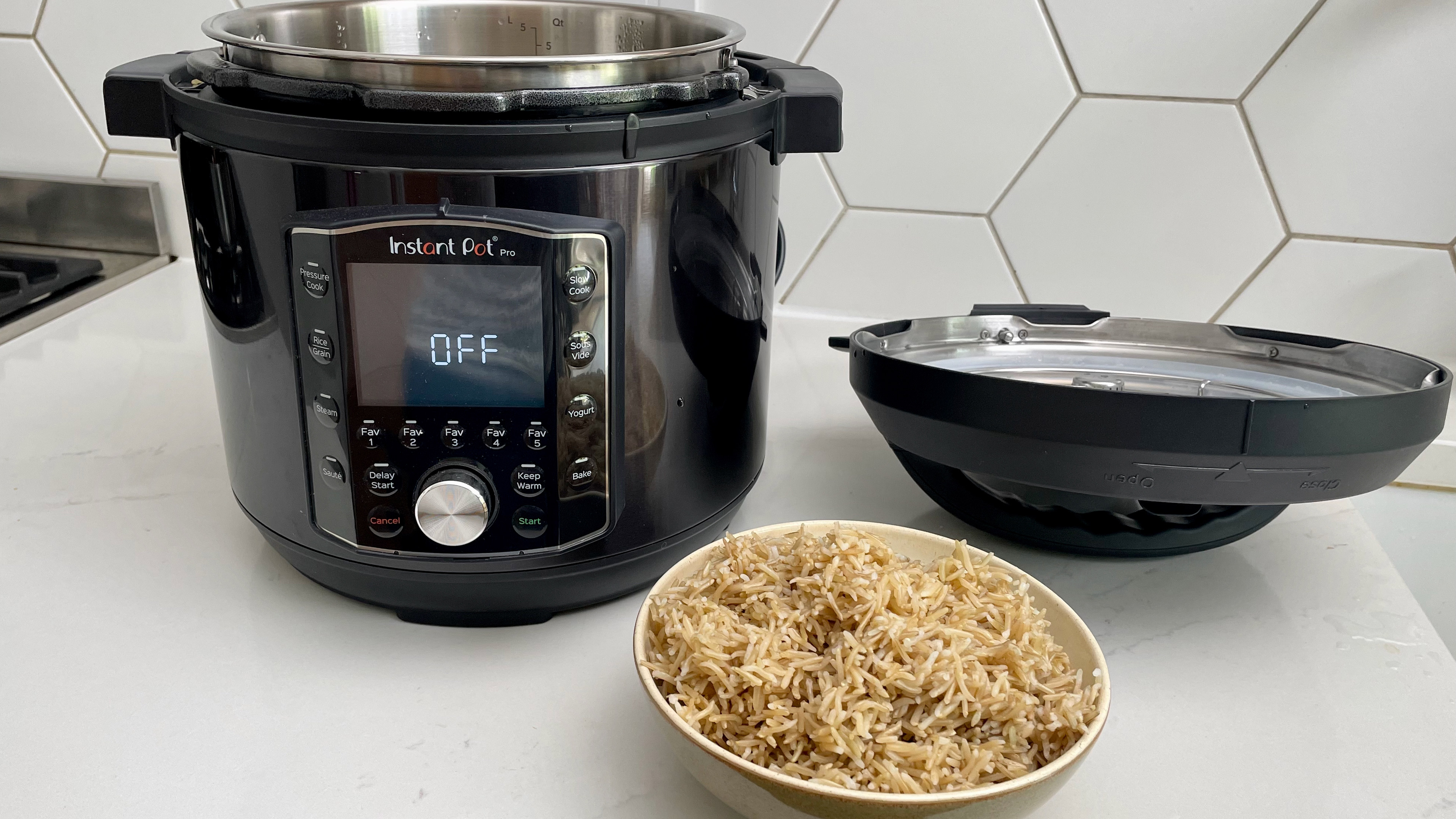 The Instant Pot Pro with the lid removed and a bowl of rice, which has been cooked in the Instant Pot