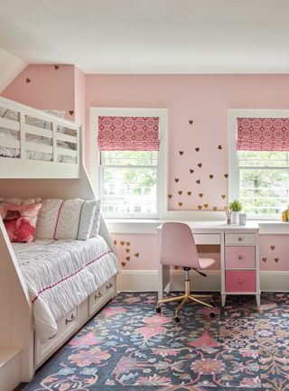 girls bunk beds in pink room with patterned rug