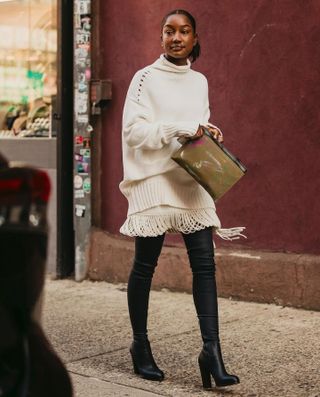 telsha wears white sweater set and long black boots