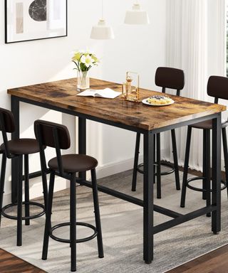 A wooden breakfast bar with four chairs