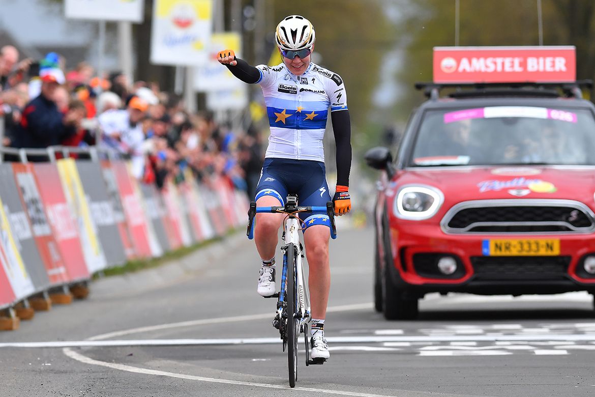Anna van der Breggen sits up and celebrates