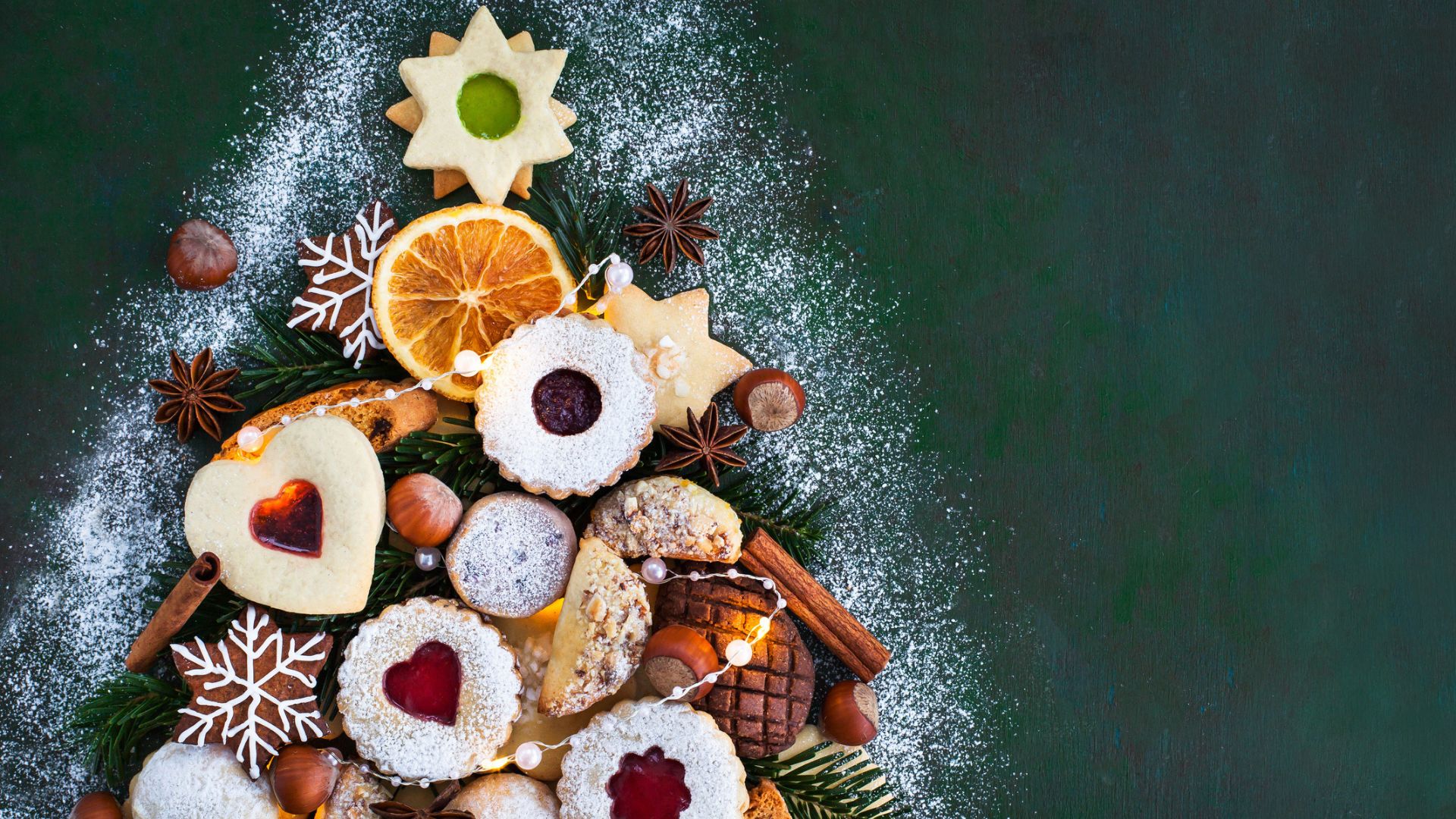 A Christmas shaped arrangement of biscuits and treats