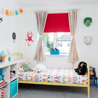 kids bedroom with white walls and colourful wall decor