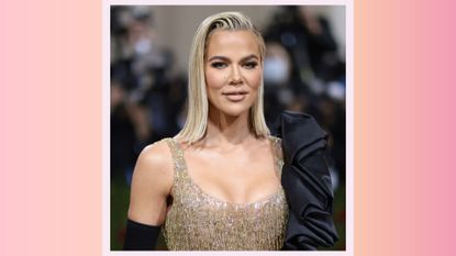 Khloé Kardashian attends The 2022 Met Gala Celebrating "In America: An Anthology of Fashion" at The Metropolitan Museum of Art on May 02, 2022 in New York City on a pink and orange background