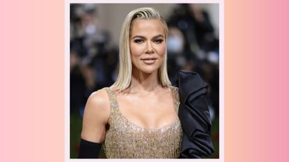 Khloé Kardashian attends The 2022 Met Gala Celebrating &quot;In America: An Anthology of Fashion&quot; at The Metropolitan Museum of Art on May 02, 2022 in New York City on a pink and orange background